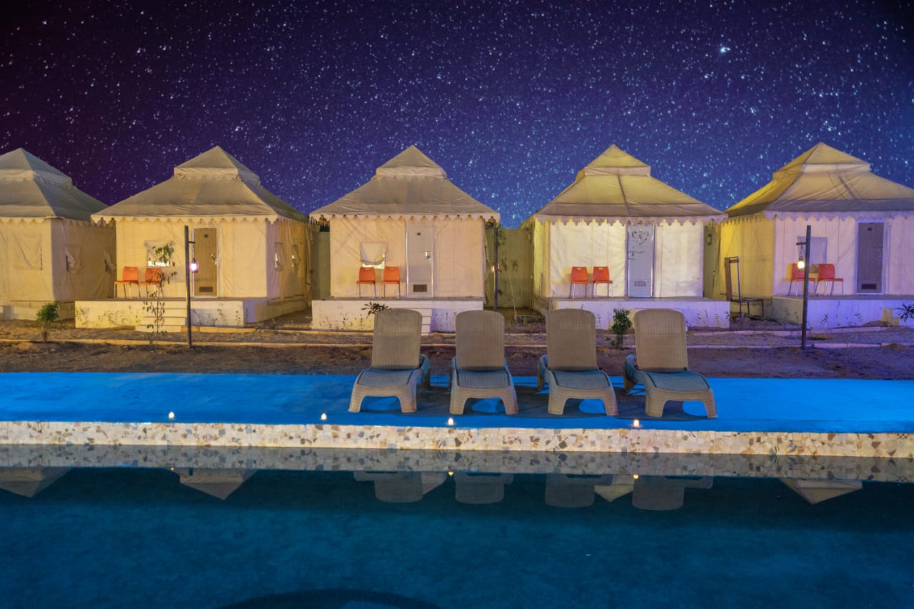 “Luxury desert camp at The Royal Janj Desert Camp in Jaisalmer with golden sand dunes.”